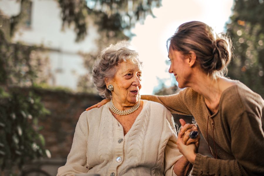 Caregiver and senior smiling together